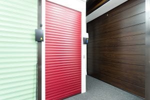 green and red roller shutters and brown panelled garage door