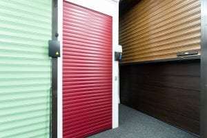 green and red roller shutters and brown panelled garage door
