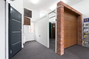 showroom with brown and white garage doors and grey security door