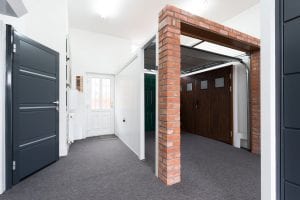 showroom with brown and white garage doors and grey security door