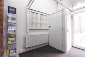 showroom with white shutters, white security doors and brochures