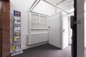 showroom with white shutters, white security doors and brochures
