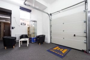 showroom with waiting area and white panelled roller door