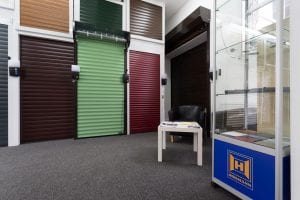 showroom with waiting area and lots of different coloured roller shutters