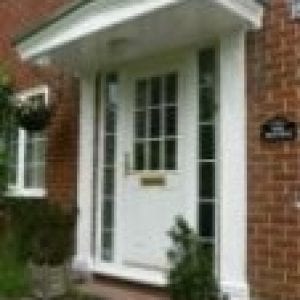 White door with a white canopies above it.