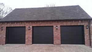three black electric roller garage doors