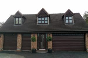 brown electric roller shutters across front of a house