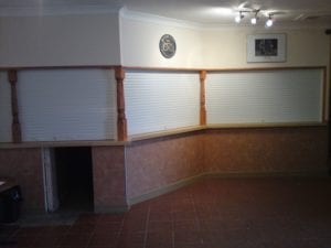 white electric roller shutters on bar