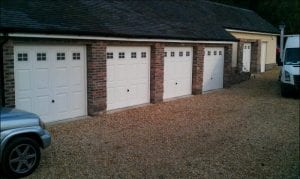 five white up and over garage doors